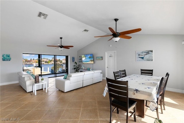 dining space featuring light tile patterned floors, ceiling fan, and vaulted ceiling