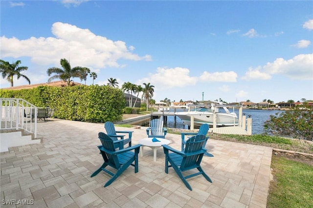 view of patio featuring a dock and a water view