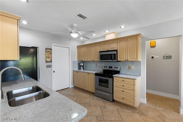 kitchen featuring sink, stainless steel appliances, light brown cabinetry, and tasteful backsplash