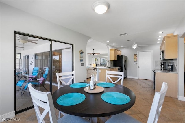 dining space with sink and ceiling fan