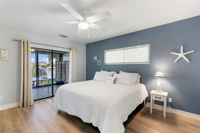 bedroom with ceiling fan, access to outside, and hardwood / wood-style floors