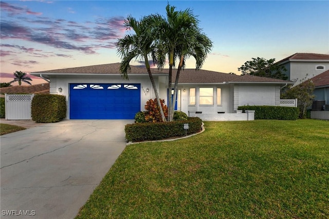 single story home with a yard and a garage