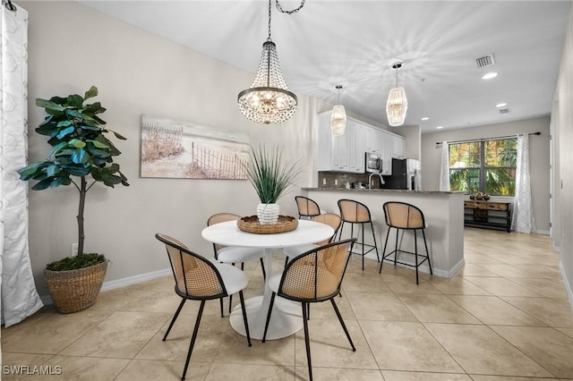 dining space featuring light tile patterned flooring and a chandelier