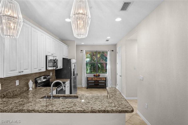 kitchen featuring white cabinets, a notable chandelier, light tile patterned flooring, kitchen peninsula, and stainless steel appliances