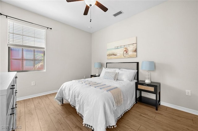 bedroom with light hardwood / wood-style floors and ceiling fan