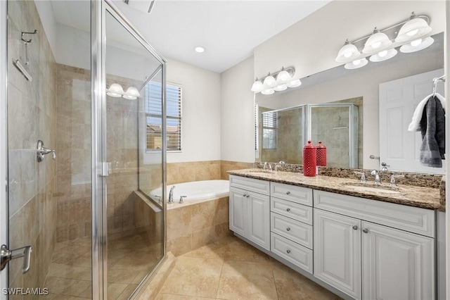 bathroom featuring vanity, tile patterned flooring, and plus walk in shower