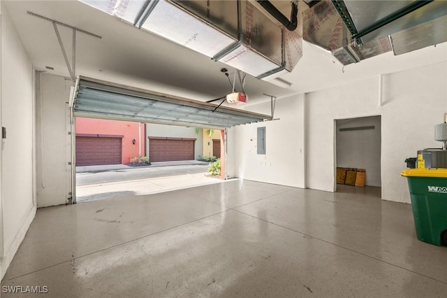 garage with electric panel and a garage door opener