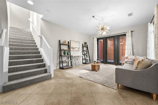 living room featuring tile patterned flooring and an inviting chandelier