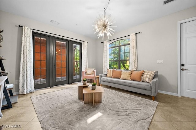 tiled living room with a notable chandelier