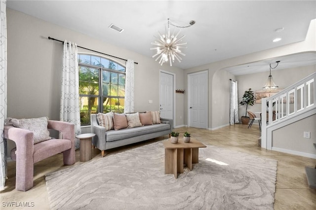 living room with light tile patterned floors and an inviting chandelier