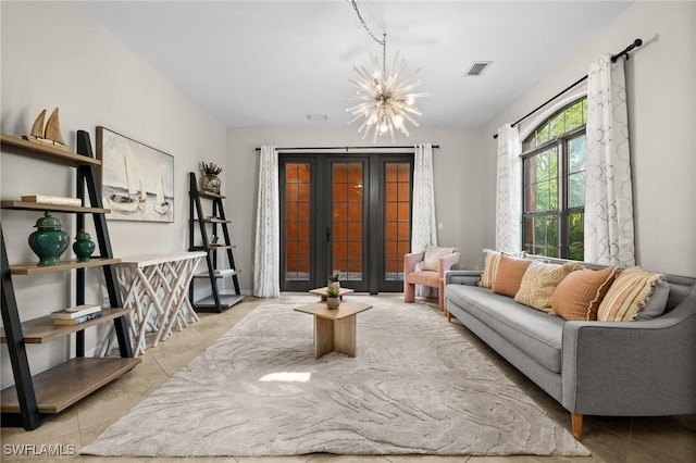 tiled living room with a notable chandelier