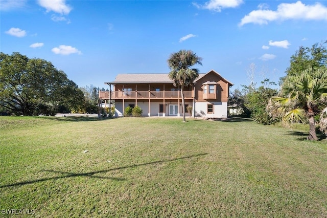 back of house featuring a yard and a deck