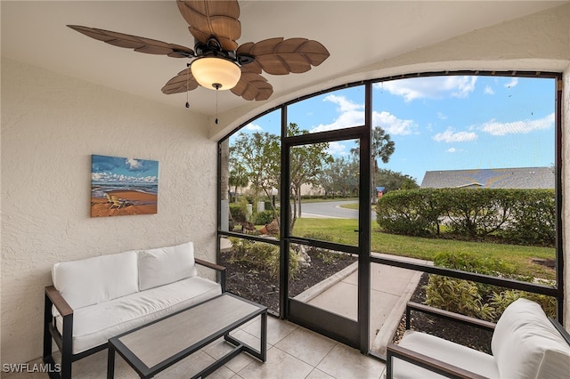 sunroom / solarium featuring ceiling fan