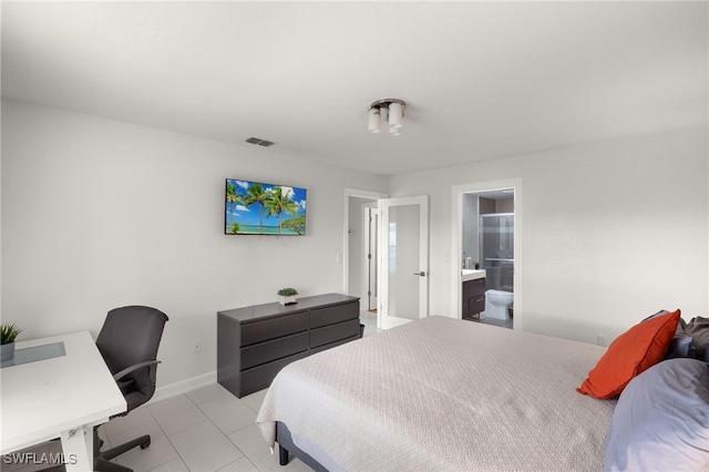 13268 Whitehaven Ln Unit 102, Fort Myers, FL 33966 - tiled bedroom with a desk, baseboards, and ensuite bath
