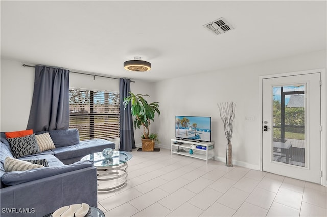 13268 Whitehaven Ln Unit 102, Fort Myers, FL 33966 - living room with plenty of natural light, baseboards, and light tile patterned floors