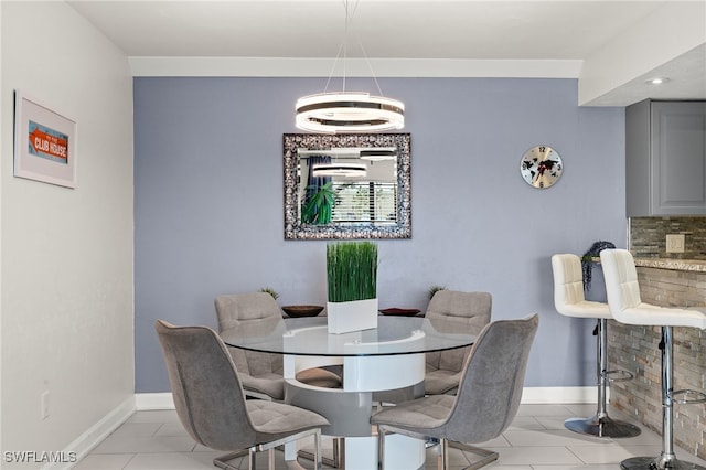 dining space featuring light tile patterned flooring and an inviting chandelier