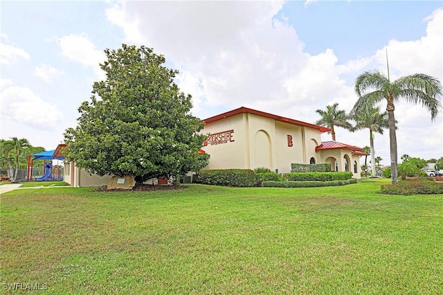 13268 Whitehaven Ln Unit 102, Fort Myers, FL 33966 - view of property exterior featuring a lawn and stucco siding