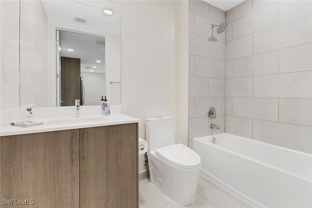 full bathroom featuring tile patterned flooring, tiled shower / bath combo, toilet, and vanity