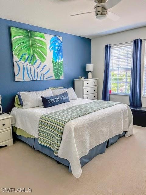 carpeted bedroom featuring ceiling fan