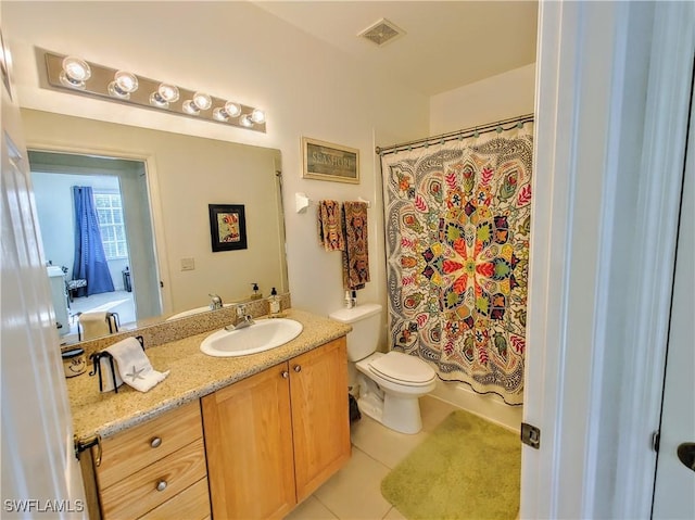 bathroom featuring tile patterned floors, curtained shower, vanity, and toilet