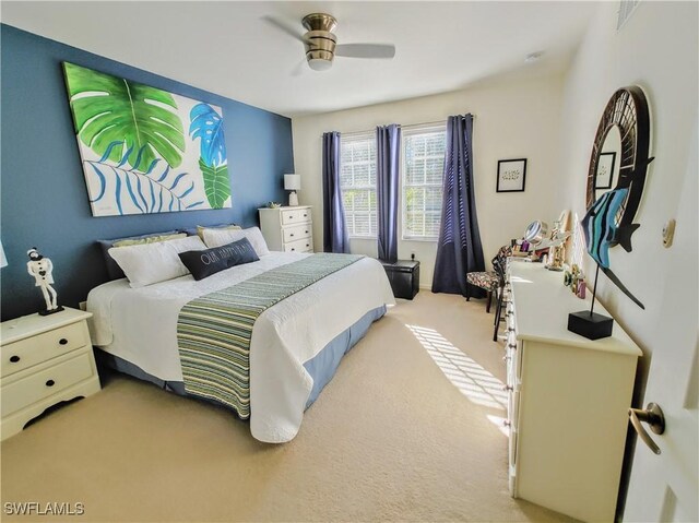 bedroom with ceiling fan and light carpet