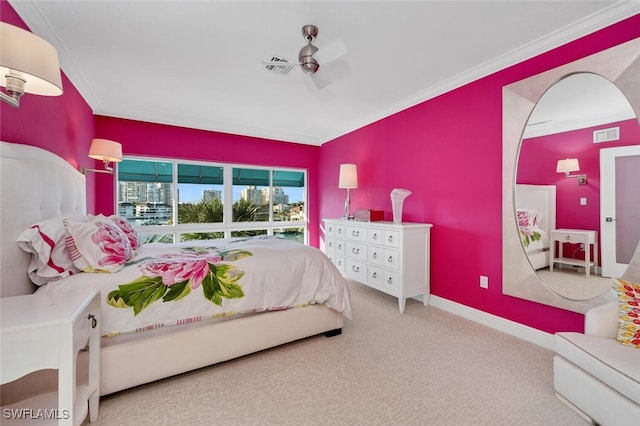 carpeted bedroom featuring ceiling fan and crown molding