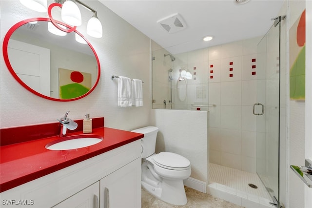 bathroom with a shower with door, vanity, and toilet