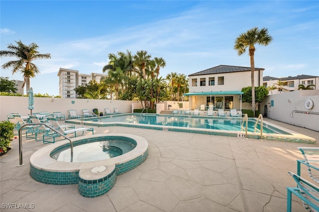 view of swimming pool with a community hot tub and a patio