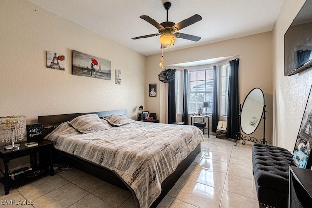 tiled bedroom featuring ceiling fan