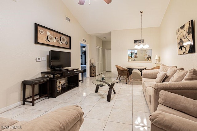 living room featuring light tile patterned floors, ceiling fan with notable chandelier, and high vaulted ceiling