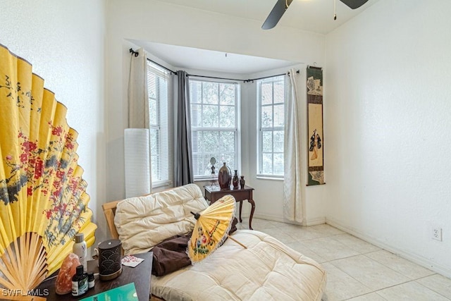 sitting room with ceiling fan and light tile patterned floors