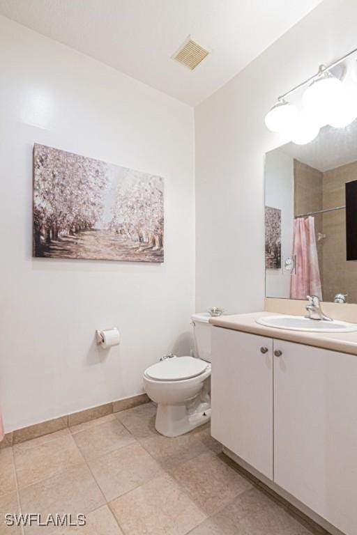 bathroom with a shower with shower curtain, vanity, toilet, and tile patterned flooring