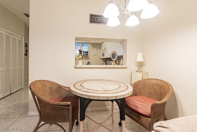 living area with a chandelier and light tile patterned flooring