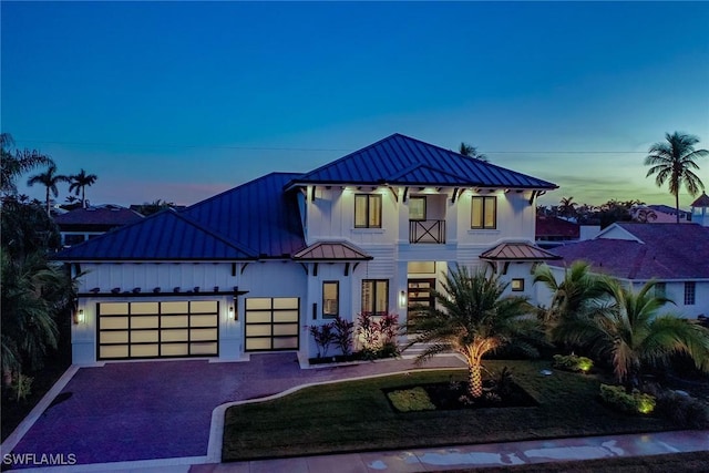 view of front of property with a balcony and a garage