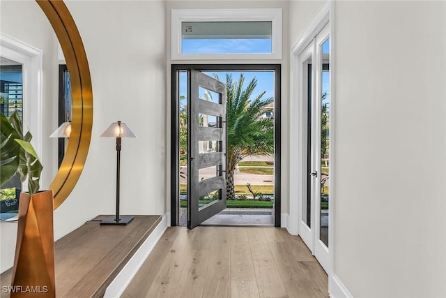 doorway to outside featuring french doors and light hardwood / wood-style flooring