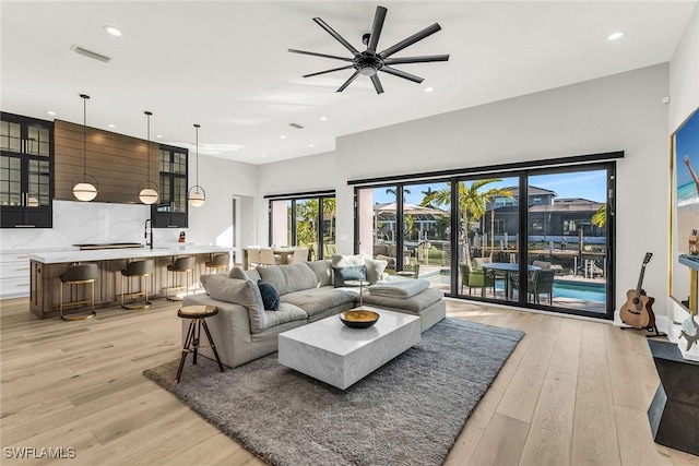 1631 Galleon Ct, Marco Island, FL 34145 - living room featuring light wood-type flooring, ceiling fan, and recessed lighting