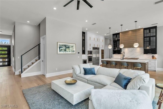 1631 Galleon Ct, Marco Island, FL 34145 - living room featuring ceiling fan, light wood finished floors, stairway, and recessed lighting