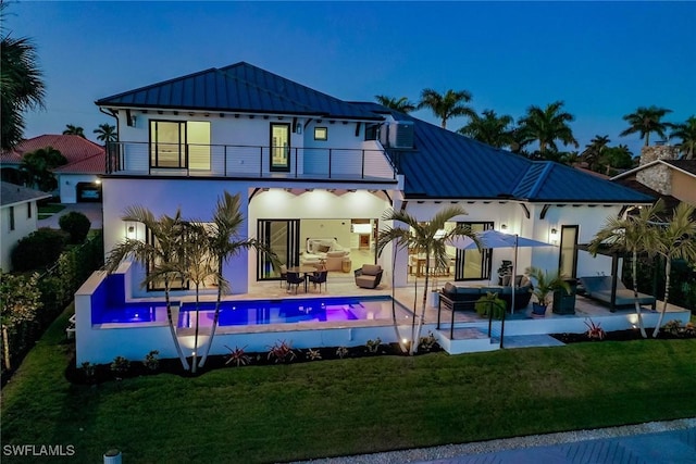 1631 Galleon Ct, Marco Island, FL 34145 - back of property with a balcony, a standing seam roof, stucco siding, and a metal roof