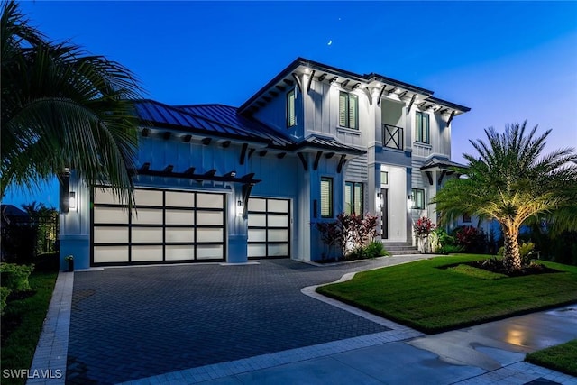 1631 Galleon Ct, Marco Island, FL 34145 - view of front of house with a garage, a front lawn, decorative driveway, and a metal roof