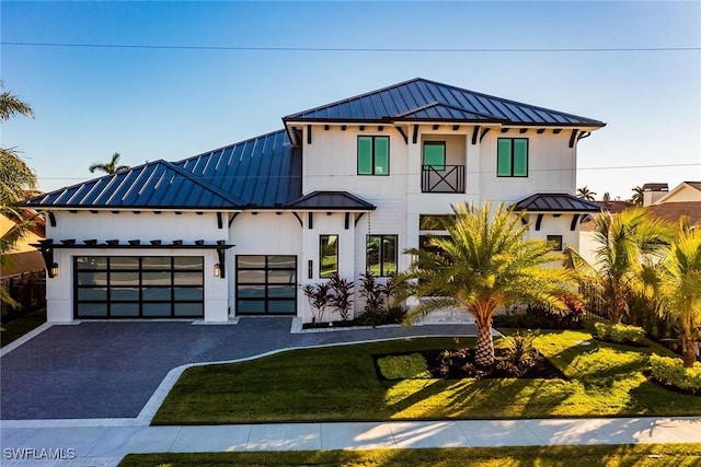 1631 Galleon Ct, Marco Island, FL 34145 - view of front facade with a standing seam roof, a metal roof, a garage, driveway, and a front yard