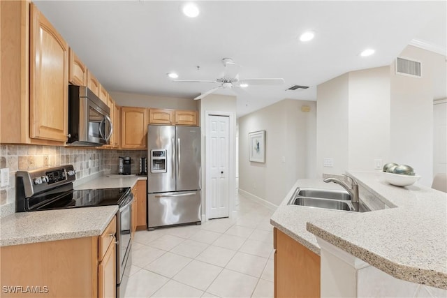 kitchen featuring stainless steel appliances, a sink, visible vents, and decorative backsplash