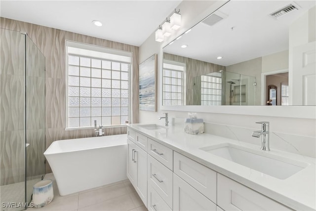 full bath featuring a stall shower, visible vents, a sink, and tile patterned floors