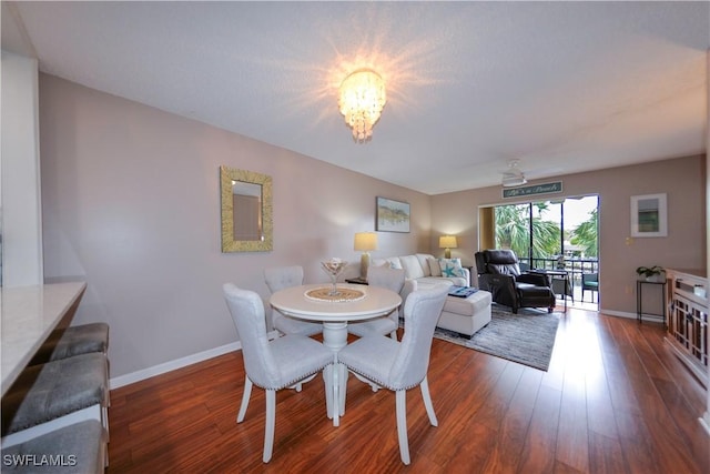 dining area featuring dark hardwood / wood-style floors and a notable chandelier