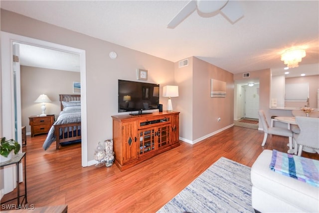 living room featuring ceiling fan and hardwood / wood-style floors