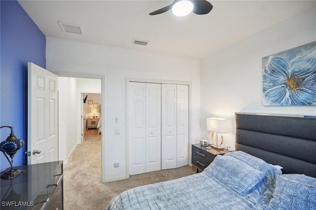 carpeted bedroom with ceiling fan and a closet