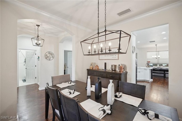 dining area with crown molding and dark hardwood / wood-style flooring