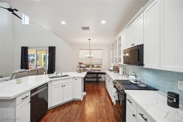 kitchen featuring appliances with stainless steel finishes, light stone counters, sink, decorative light fixtures, and white cabinetry