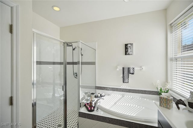 bathroom with vanity and separate shower and tub