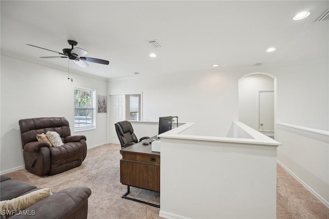 carpeted home office featuring ceiling fan and ornamental molding