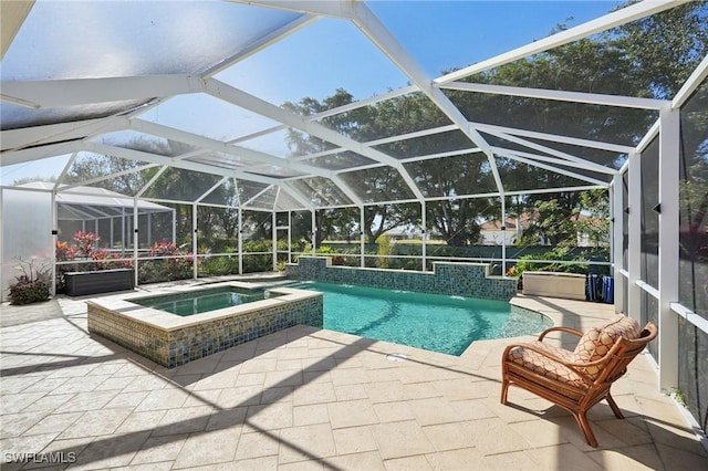 view of pool featuring a patio area, an in ground hot tub, pool water feature, and glass enclosure